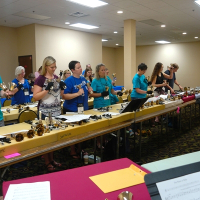 Handbell duo Larry and Carla lead an 8-Bell Music class at Area 8 festival in Omaha, Nebraska
