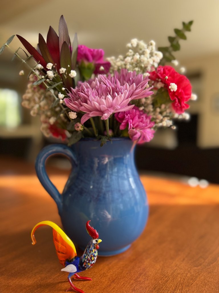Flowers and glass rooster